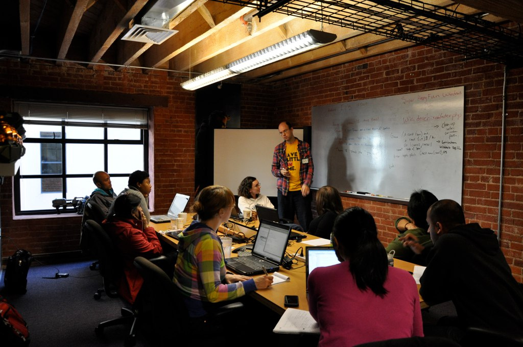 A RailsBridge class in a room with exposed brick